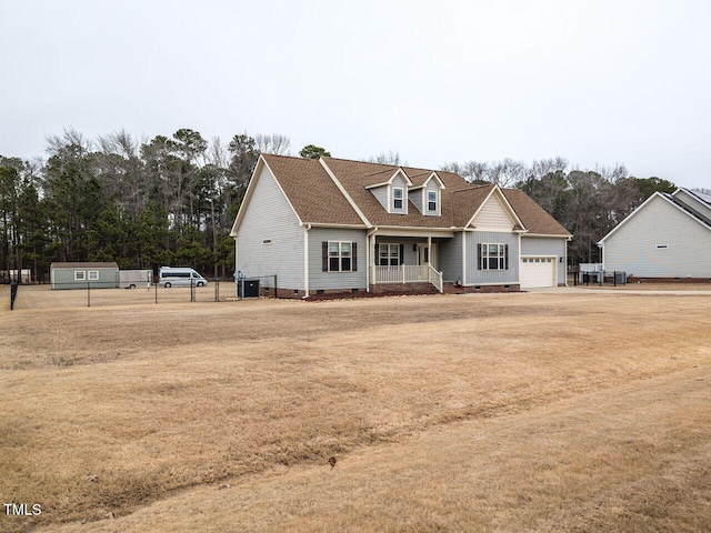 view of front of home featuring a porch, a garage, and a front yard