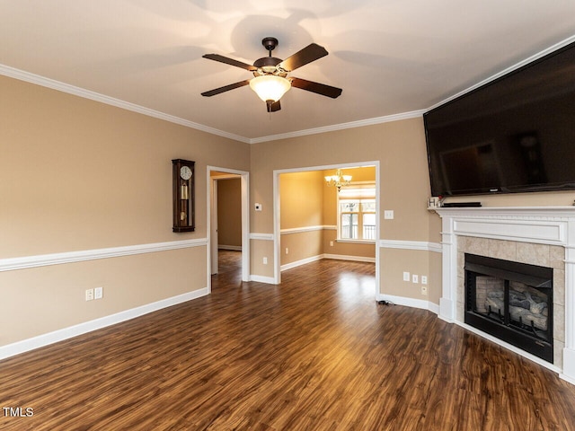 unfurnished living room with dark hardwood / wood-style floors, ornamental molding, a fireplace, and ceiling fan with notable chandelier