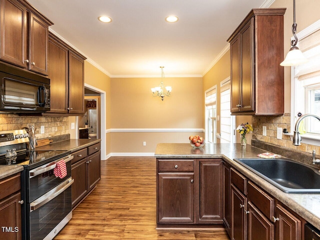 kitchen with sink, range with two ovens, ornamental molding, hanging light fixtures, and kitchen peninsula