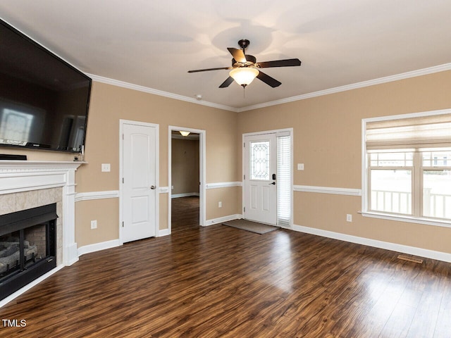 unfurnished living room featuring ceiling fan, a fireplace, ornamental molding, and dark hardwood / wood-style floors