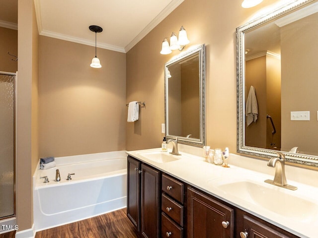 bathroom featuring hardwood / wood-style flooring, vanity, a bath, and crown molding