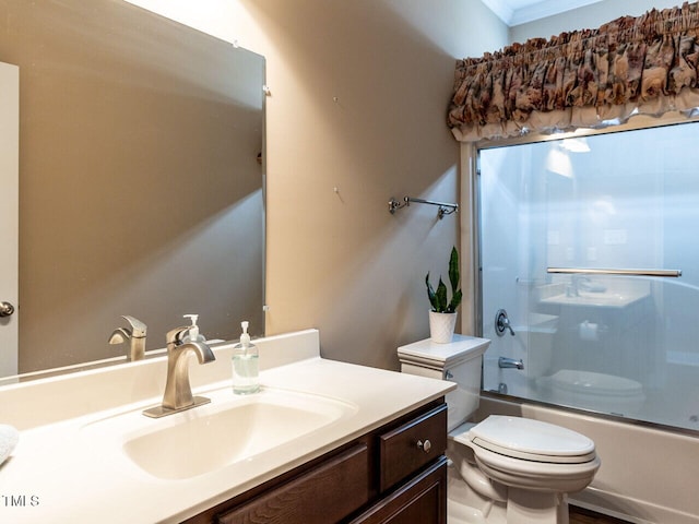 full bathroom with toilet, vanity, and shower / bath combination with glass door