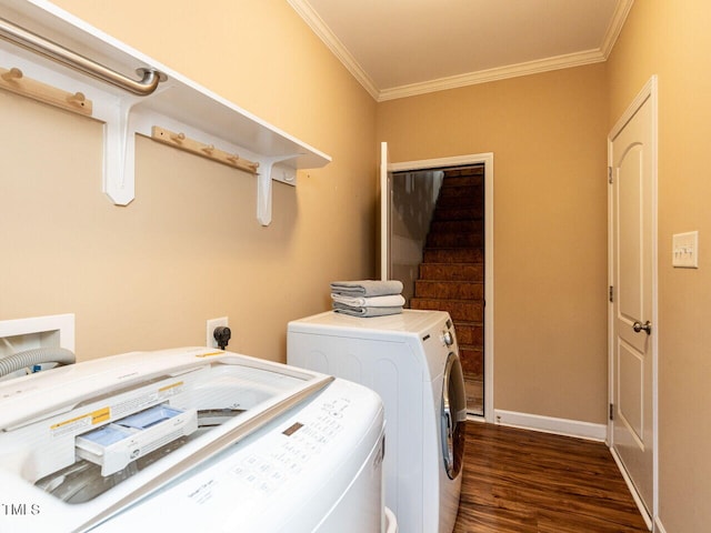 clothes washing area with crown molding, dark hardwood / wood-style flooring, and washing machine and dryer