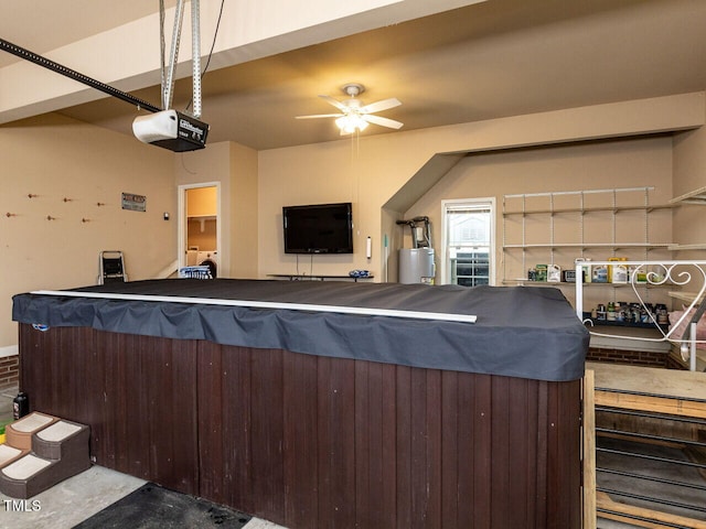 interior space featuring a garage door opener, water heater, and ceiling fan