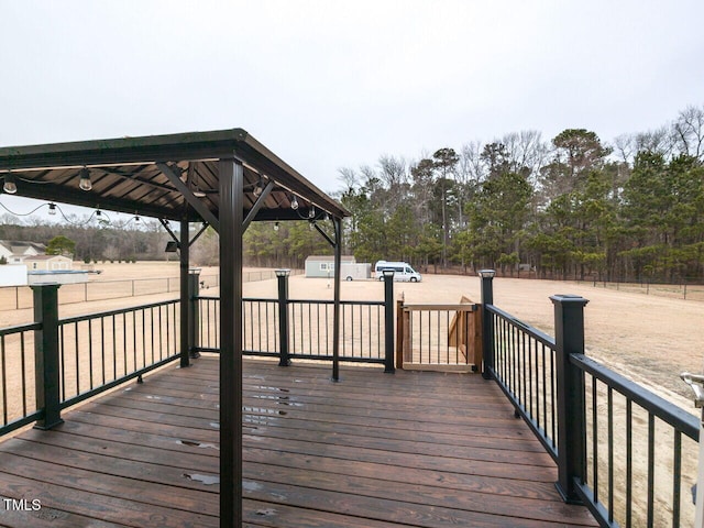 wooden terrace featuring a gazebo