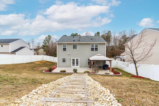 rear view of house with a patio area, a yard, a fenced backyard, and a gazebo