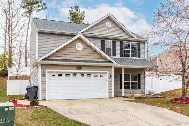 traditional home with driveway, fence, and roof with shingles