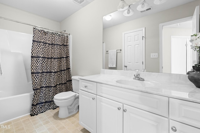 bathroom featuring visible vents, vanity, toilet, and shower / bath combo with shower curtain