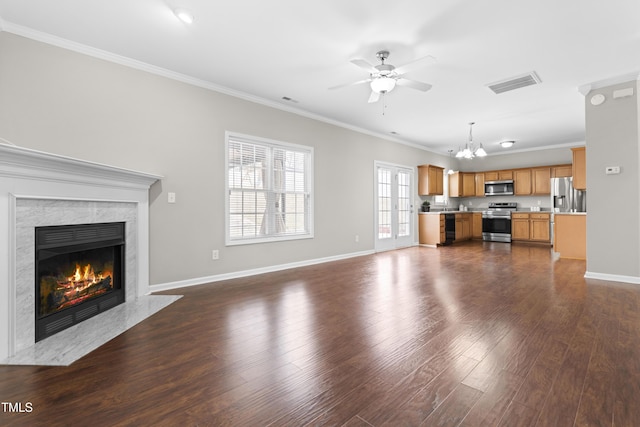 unfurnished living room featuring a fireplace, crown molding, visible vents, dark wood-type flooring, and baseboards