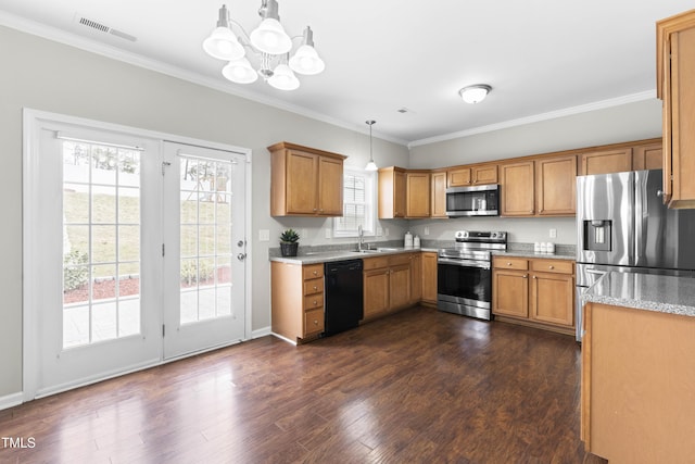 kitchen featuring a sink, visible vents, appliances with stainless steel finishes, brown cabinets, and dark wood finished floors