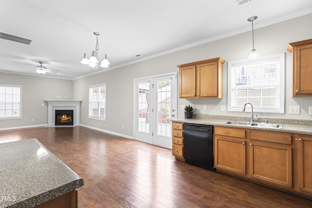 kitchen with a fireplace with flush hearth, a sink, visible vents, brown cabinets, and dishwasher