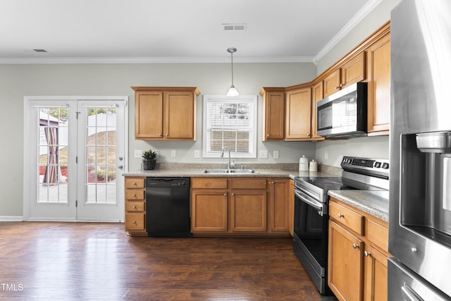 kitchen with visible vents, appliances with stainless steel finishes, brown cabinets, dark wood-type flooring, and a sink