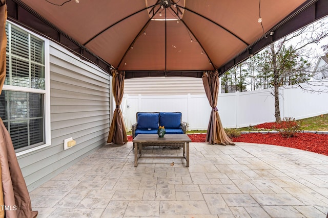 view of patio with fence and a gazebo