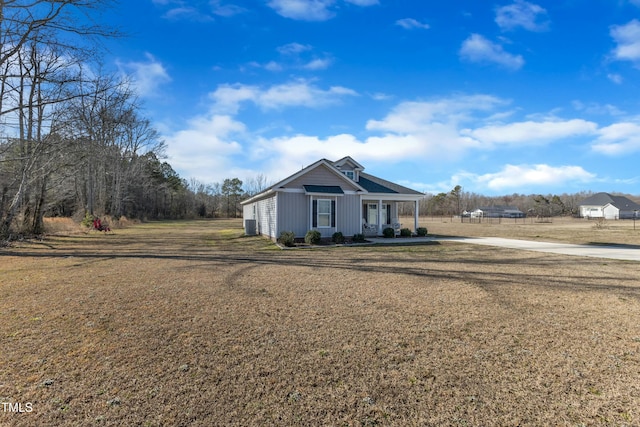 view of front of home with a front yard and covered porch