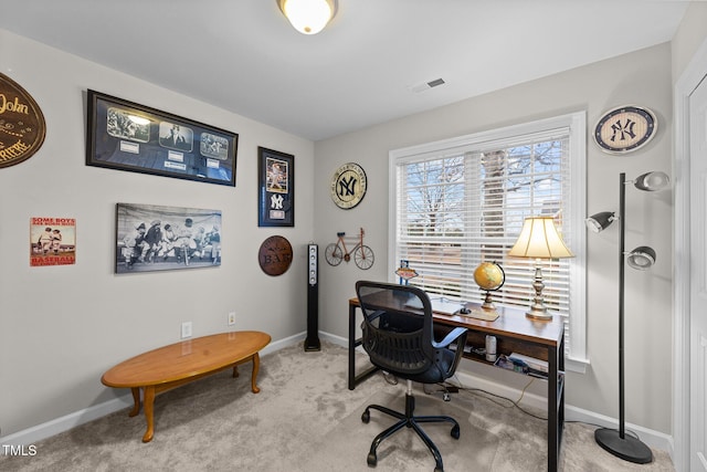 office area with visible vents, baseboards, and light colored carpet