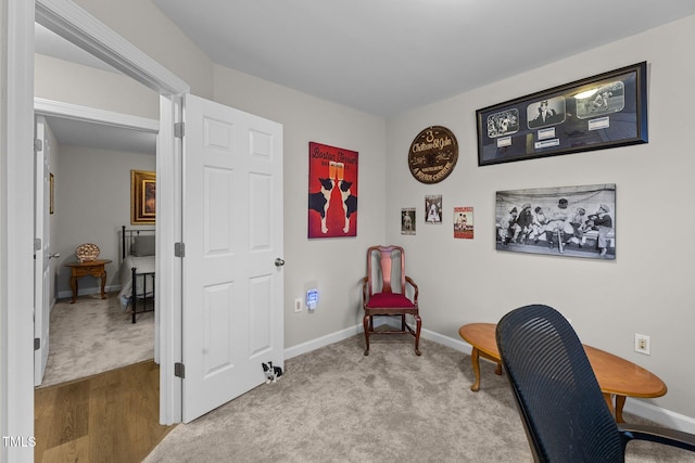 home office featuring light wood finished floors, light colored carpet, and baseboards