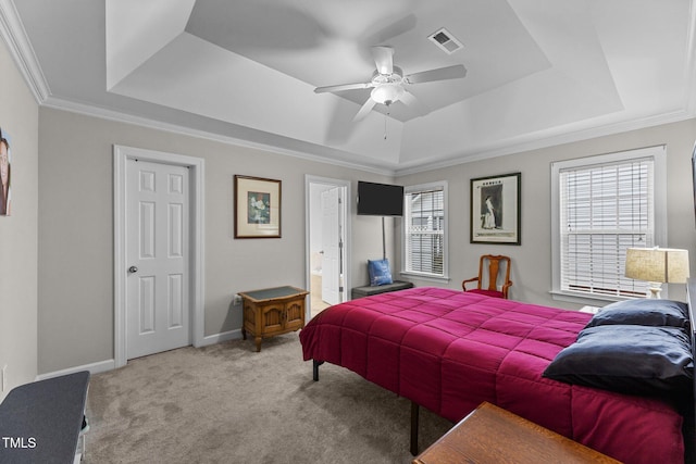 bedroom with a raised ceiling, visible vents, light carpet, and multiple windows