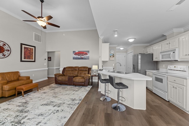 kitchen with open floor plan, light countertops, white appliances, and visible vents