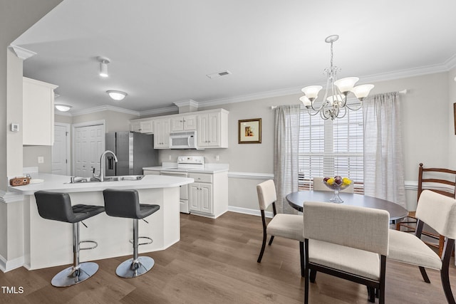 kitchen featuring light countertops, white appliances, a sink, and white cabinets