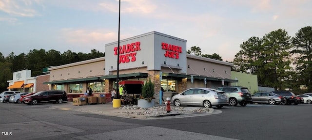 view of building exterior with uncovered parking