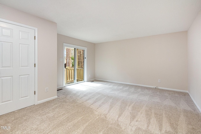 empty room with carpet flooring and baseboards