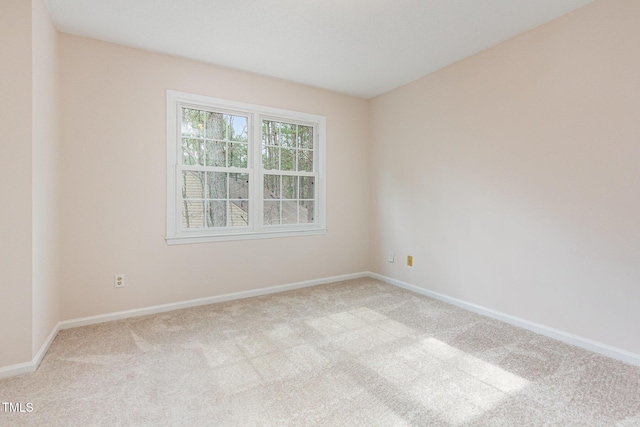 carpeted empty room with baseboards