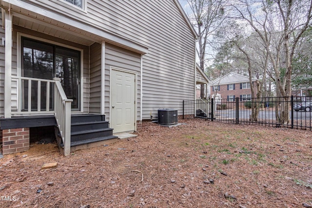 exterior space featuring cooling unit and fence