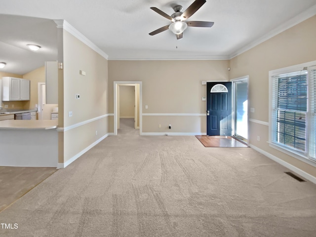 unfurnished room featuring ornamental molding, light colored carpet, and ceiling fan