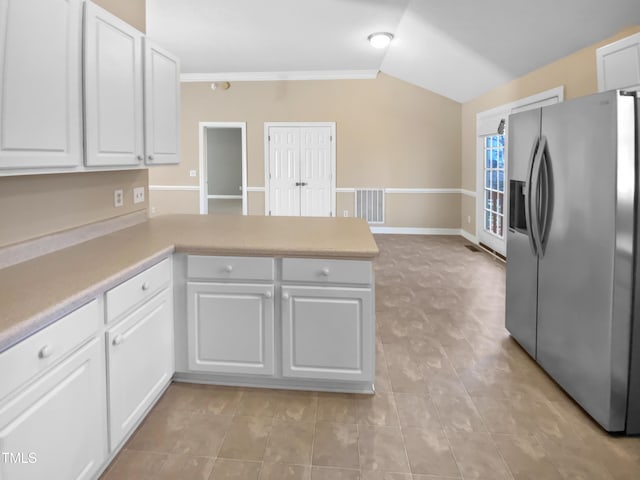 kitchen with crown molding, vaulted ceiling, stainless steel fridge with ice dispenser, kitchen peninsula, and white cabinets