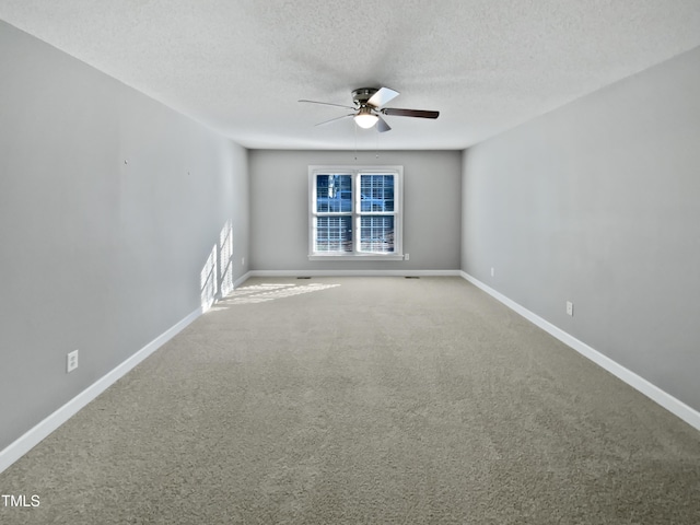 spare room featuring carpet, a textured ceiling, and ceiling fan