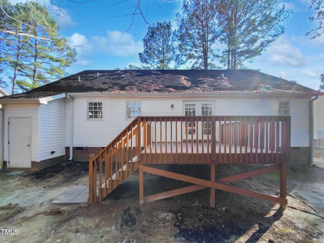 rear view of house featuring a wooden deck