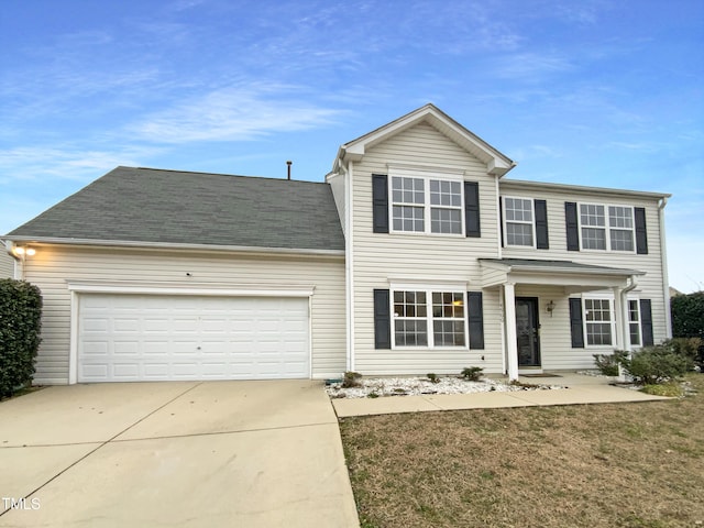 view of front of home with a garage and a front yard