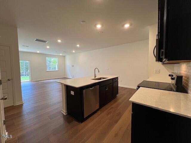 144 Parker Ln, Mebane, NC 27302 - kitchen featuring visible vents, range with electric cooktop, a sink, dark cabinetry, and stainless steel dishwasher