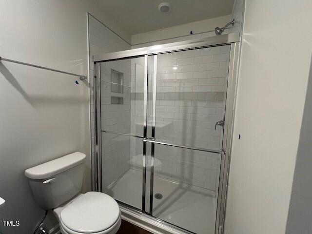 144 Parker Ln, Mebane, NC 27302 - bathroom featuring a shower stall and toilet