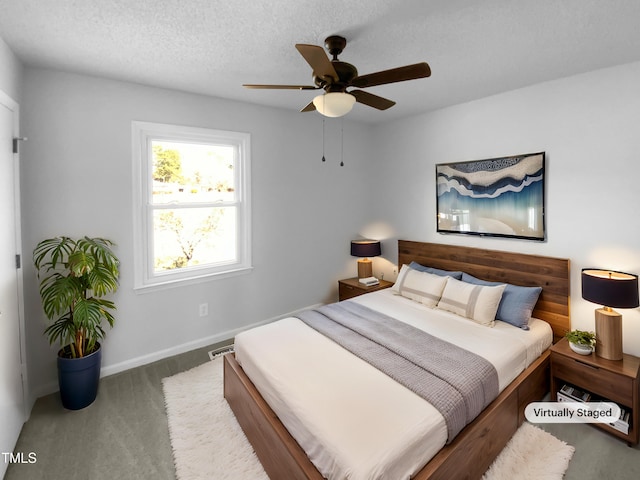 bedroom featuring ceiling fan and a textured ceiling