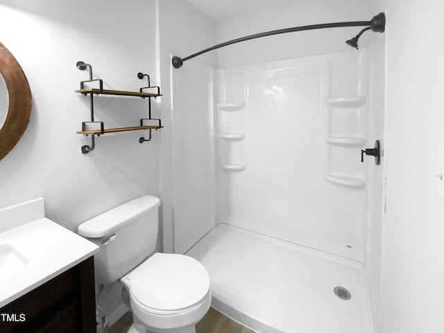 bathroom with vanity, toilet, and walk in shower