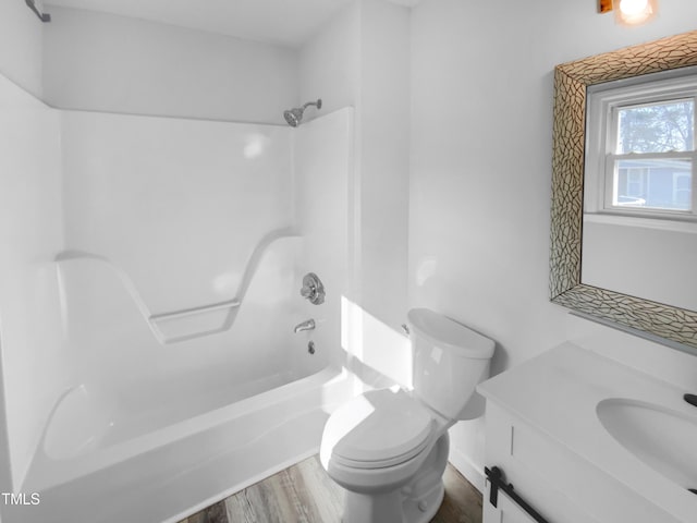 full bathroom featuring shower / bathing tub combination, hardwood / wood-style floors, vanity, and toilet