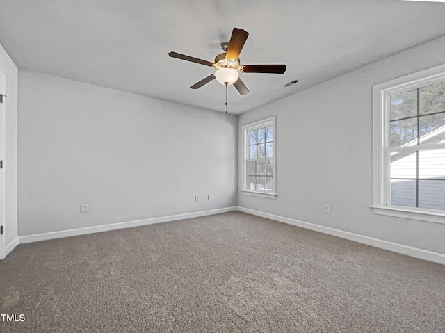 carpeted empty room featuring ceiling fan