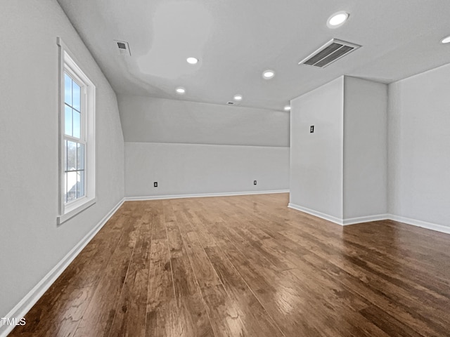 additional living space featuring lofted ceiling and hardwood / wood-style flooring