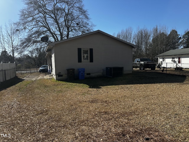 view of side of home featuring a yard and central air condition unit