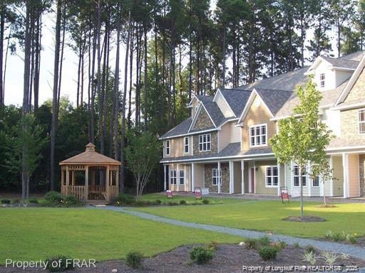 view of front facade with a gazebo and a front lawn