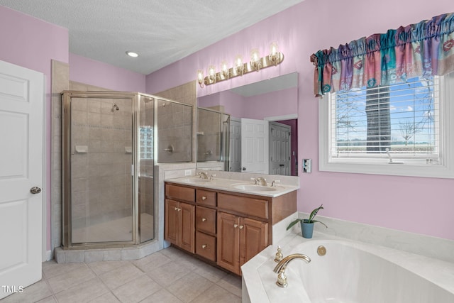 bathroom with vanity, shower with separate bathtub, tile patterned flooring, and a textured ceiling