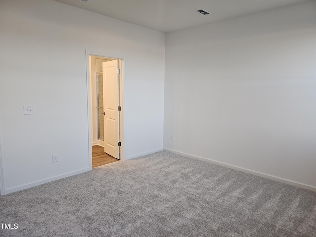 spare room with light colored carpet