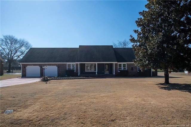 view of front of property with a garage and a front lawn