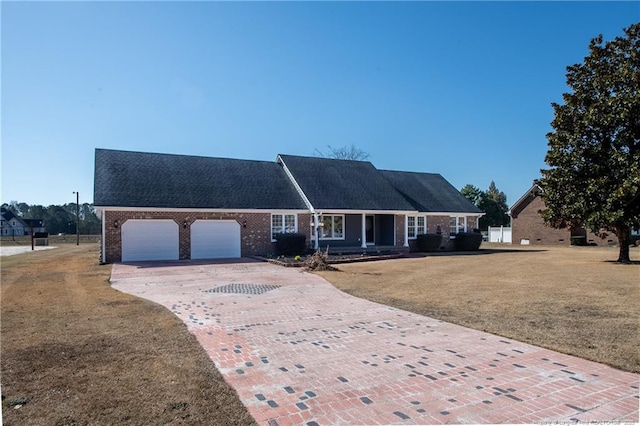 view of front of home featuring a garage and a front lawn