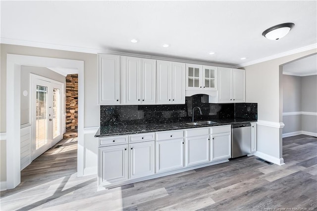 kitchen with white cabinetry, sink, decorative backsplash, stainless steel dishwasher, and crown molding