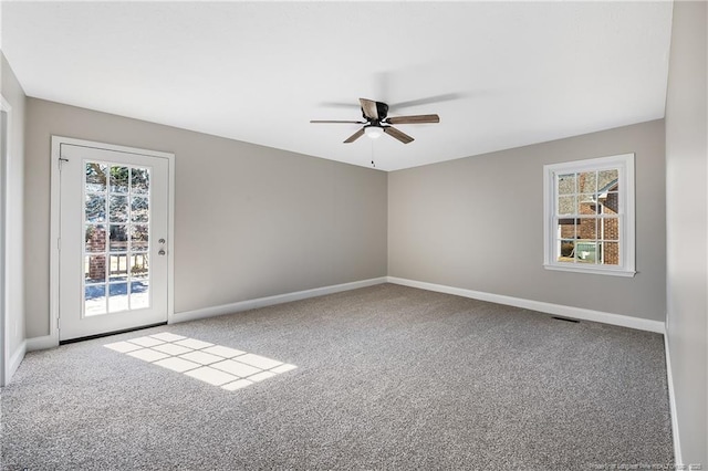 empty room featuring ceiling fan, a healthy amount of sunlight, and carpet floors