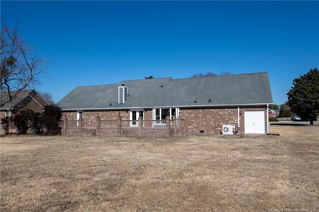 rear view of property with a yard