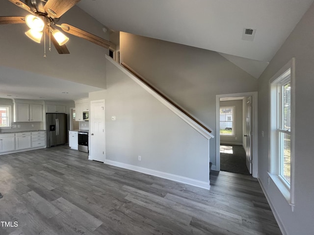 unfurnished living room featuring hardwood / wood-style flooring, high vaulted ceiling, and ceiling fan