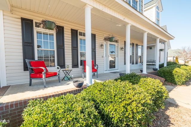 view of exterior entry featuring covered porch